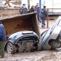 Giant pothole swallows three cars and a truck