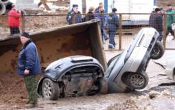 Giant pothole swallows three cars and a truck