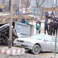 Giant pothole swallows three cars and a truck