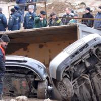 Giant pothole swallows three cars and a truck