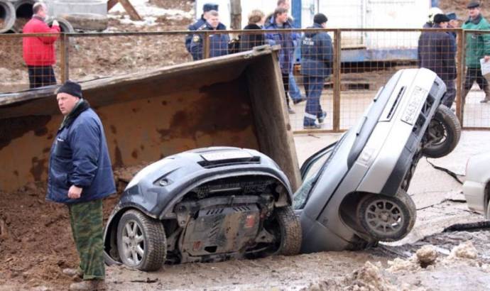 Giant pothole swallows three cars and a truck