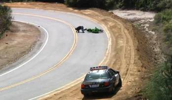 Video: Biker lowsides infront of Police