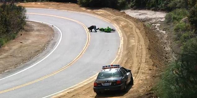 Video: Biker lowsides infront of Police