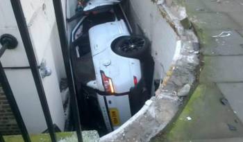 2014 Range Rover Sport ends up in front of a basement flat