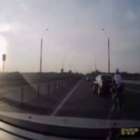 The luckiest biker on the planet - He rear-ended a car and landed on its feet on the moving vehicle