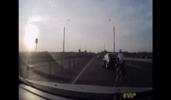 The luckiest biker on the planet - He rear-ended a car and landed on its feet on the moving vehicle