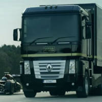 Lotus F1 Team truck jumps over Formula 1 car
