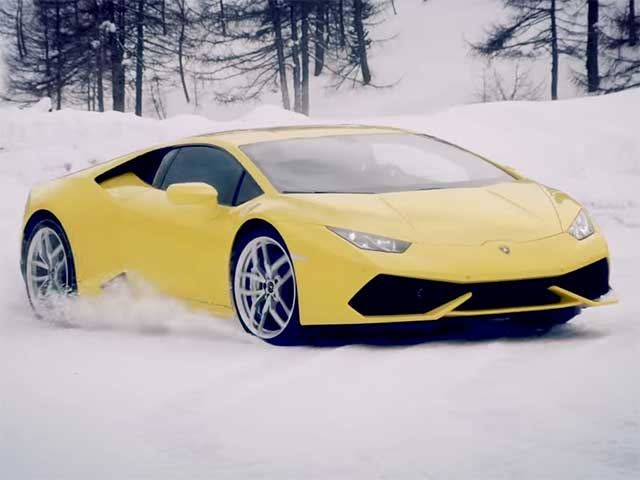 Lamborghini Huracan racing a snowmobile