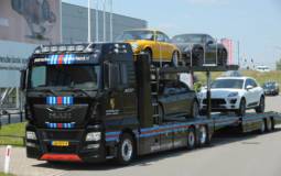 MAN truck in Martini Racing livery for transporting Porsche cars