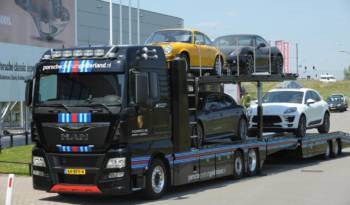 MAN truck in Martini Racing livery for transporting Porsche cars